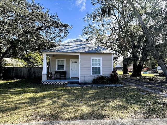 bungalow with a porch and a front lawn