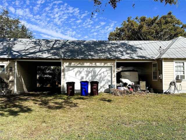 view of home's exterior featuring cooling unit, a garage, and a lawn