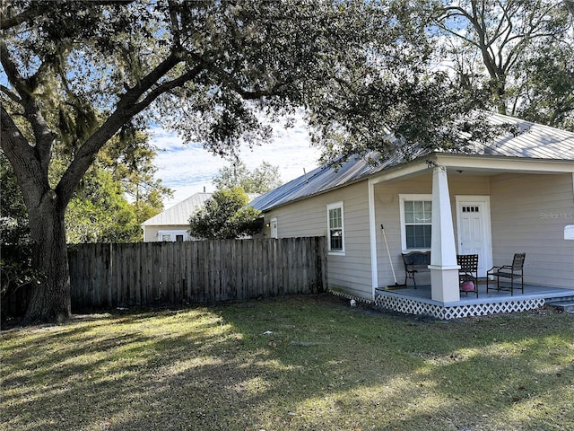 view of side of home with a yard