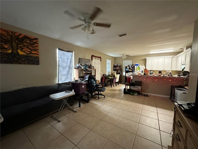 living room with ceiling fan and light tile patterned flooring