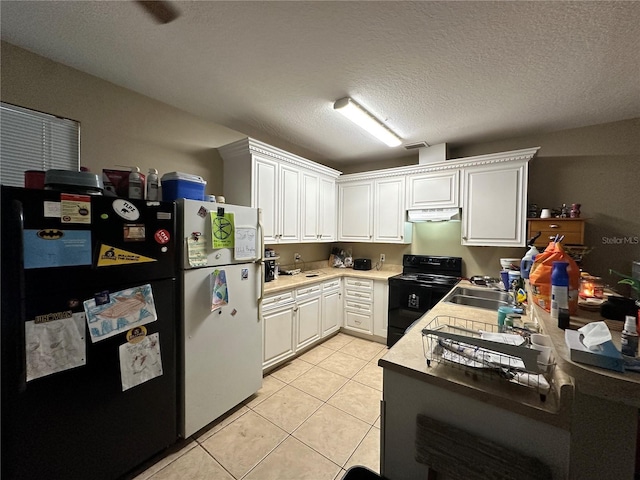 kitchen featuring light tile patterned floors, black appliances, sink, and white cabinets