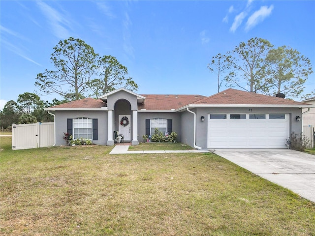 ranch-style house featuring a front lawn and a garage