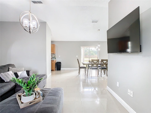 tiled living room with a chandelier