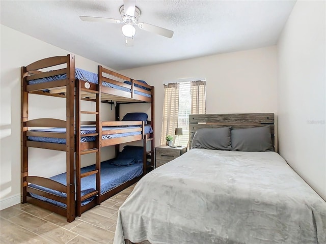 bedroom with a textured ceiling and ceiling fan