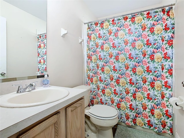 bathroom featuring toilet and vanity