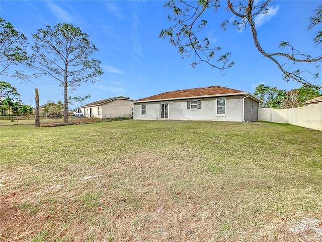 back of property featuring a yard