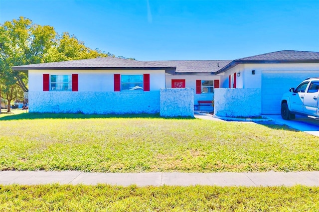 single story home featuring a front lawn and a garage