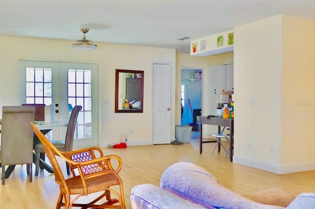 living area featuring wood-type flooring and french doors