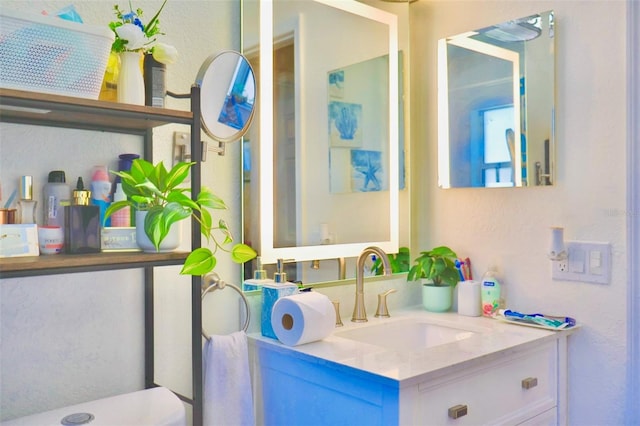 bathroom featuring toilet and vanity