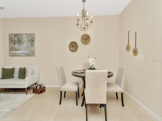 dining area featuring an inviting chandelier and light tile patterned floors