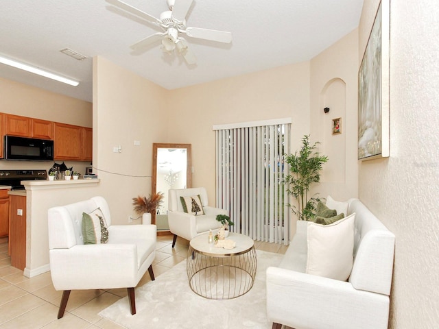 sitting room with ceiling fan and light tile patterned floors