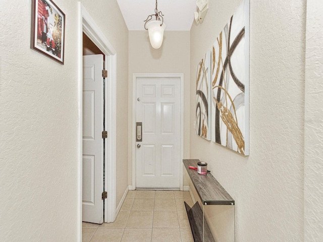 doorway with light tile patterned floors