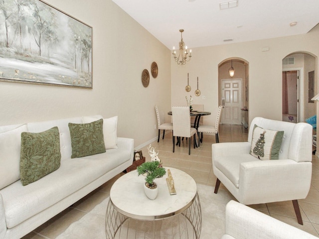 tiled living room with an inviting chandelier