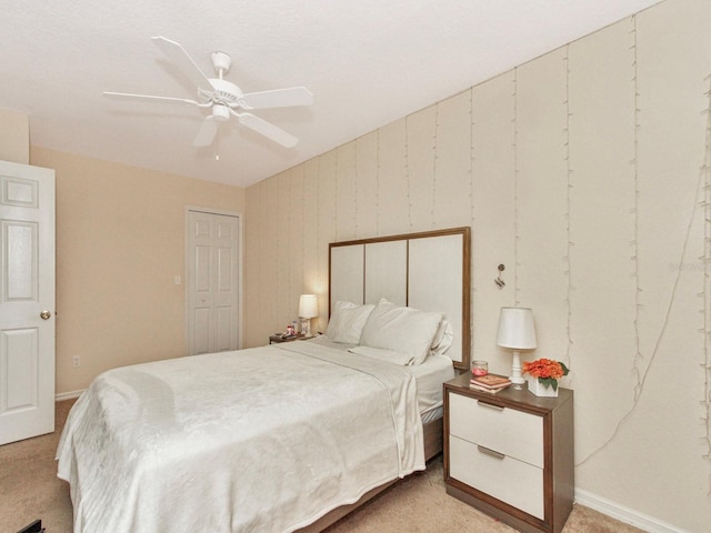 bedroom with ceiling fan and light carpet