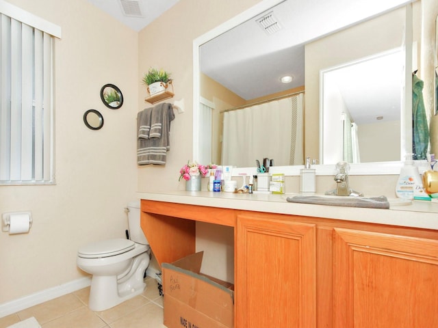 bathroom featuring tile patterned floors, vanity, and toilet