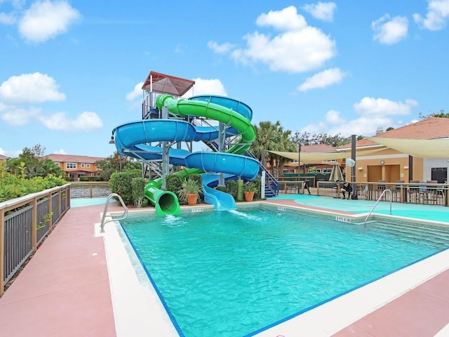 view of swimming pool with a water slide