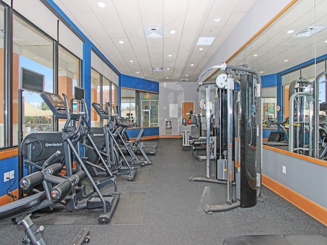 exercise room featuring a drop ceiling