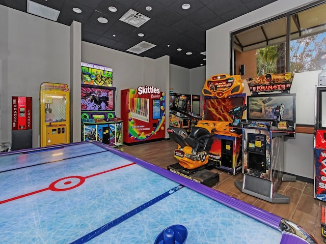 recreation room with hardwood / wood-style floors and a drop ceiling