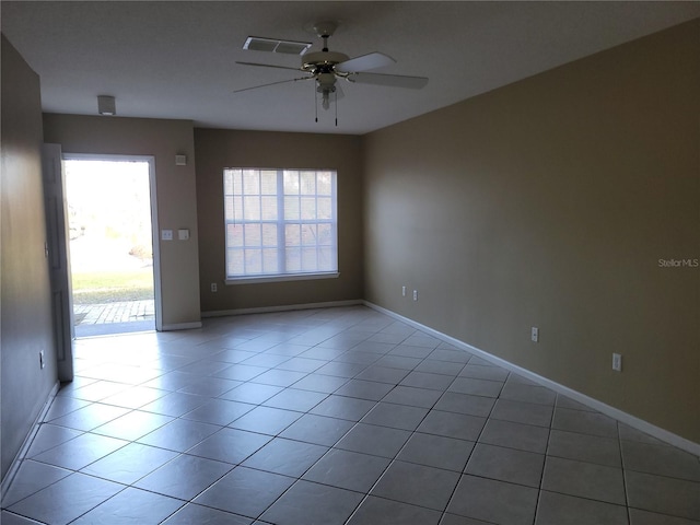 unfurnished room with ceiling fan and light tile patterned flooring