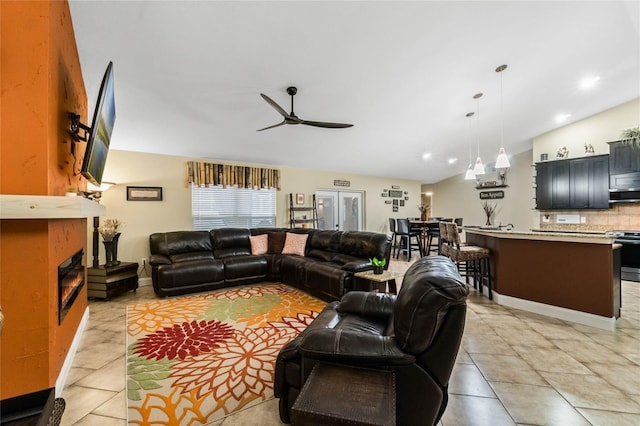 tiled living room with vaulted ceiling and ceiling fan