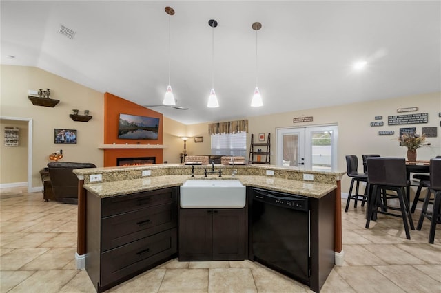 kitchen featuring lofted ceiling, sink, dishwasher, hanging light fixtures, and french doors