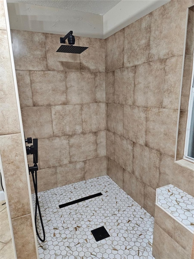 interior details with a tile shower