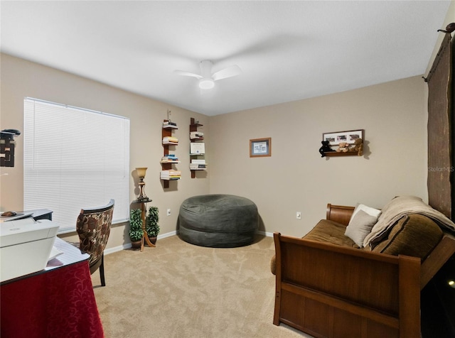 carpeted office space featuring ceiling fan