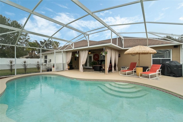 back of property with a patio, a fenced in pool, and glass enclosure