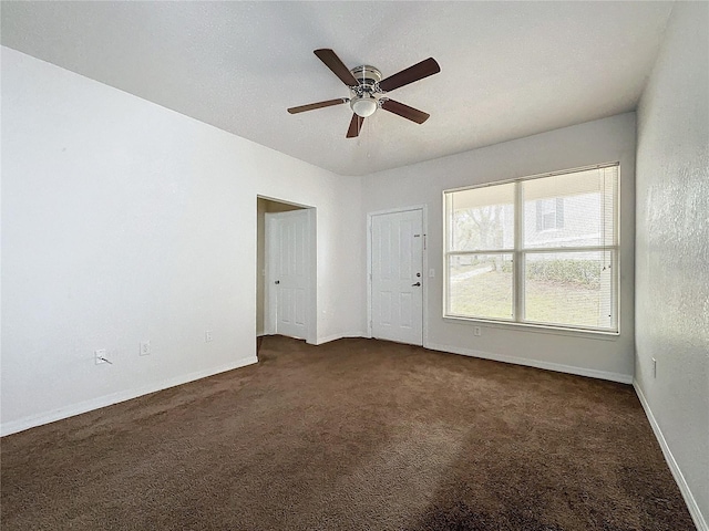 carpeted empty room with ceiling fan