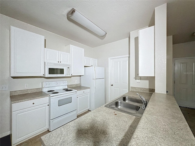 kitchen with sink, white appliances, white cabinetry, and a textured ceiling