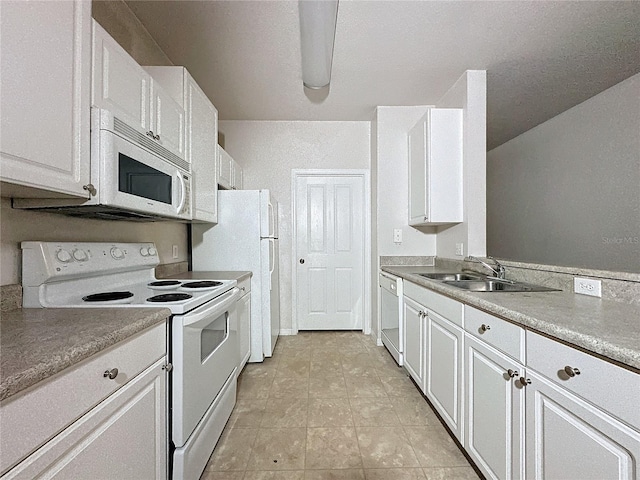 kitchen featuring light tile patterned flooring, sink, white cabinets, and white appliances