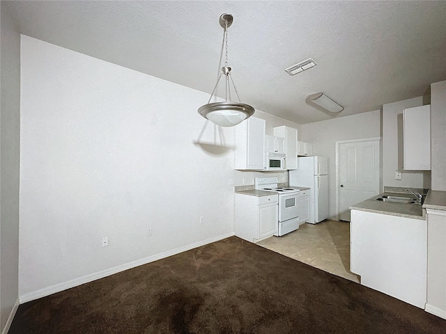 kitchen with white appliances, white cabinets, decorative light fixtures, sink, and light colored carpet