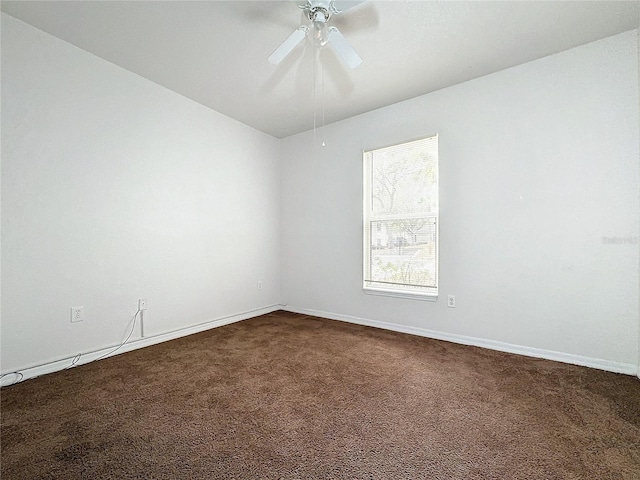 carpeted empty room featuring ceiling fan