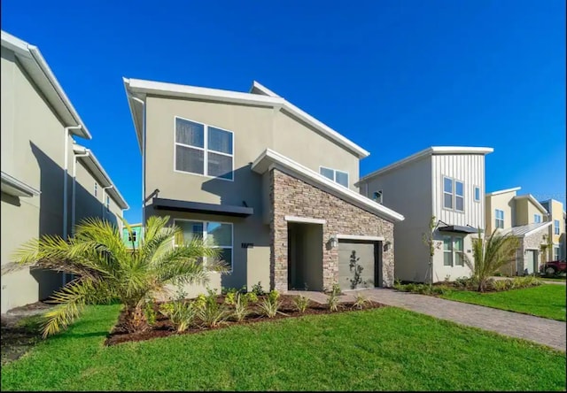 view of front of property with a front lawn and a garage