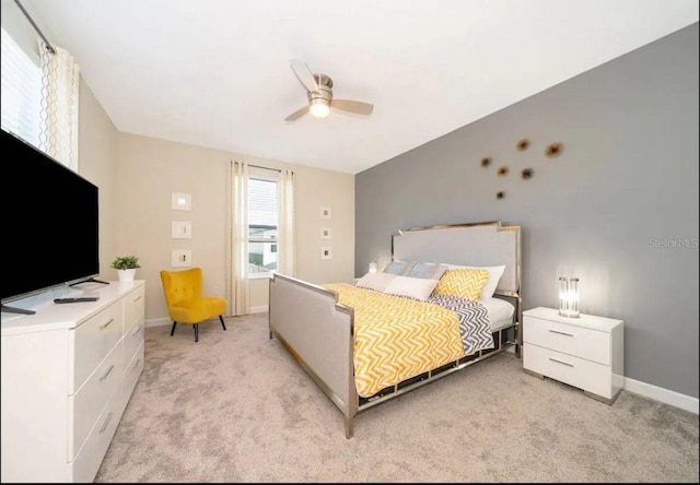 bedroom with ceiling fan and light colored carpet