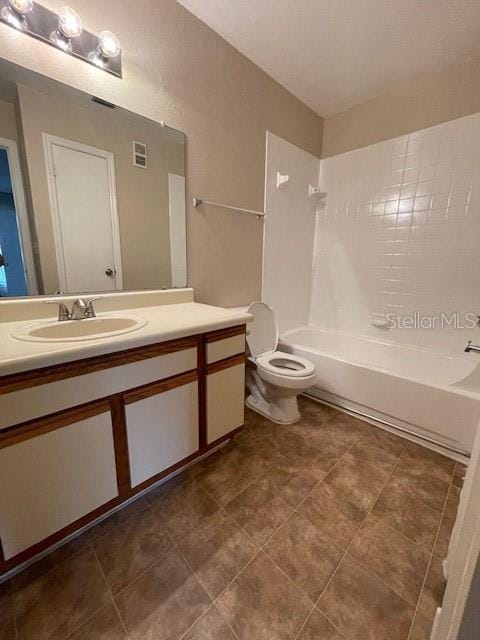 full bathroom featuring toilet, vanity, and  shower combination