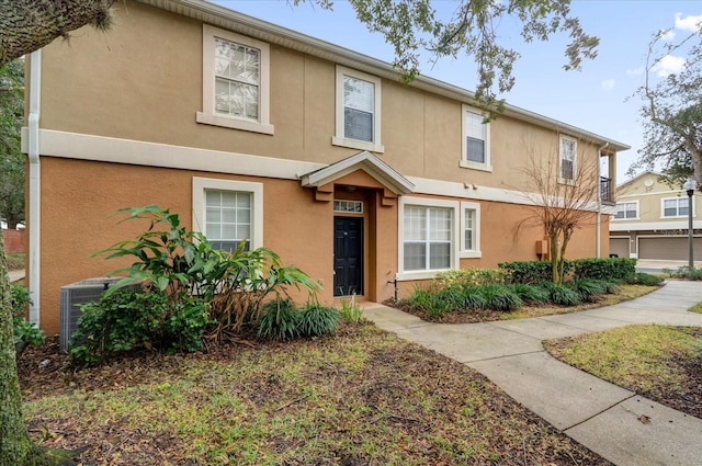 view of property with central AC and stucco siding