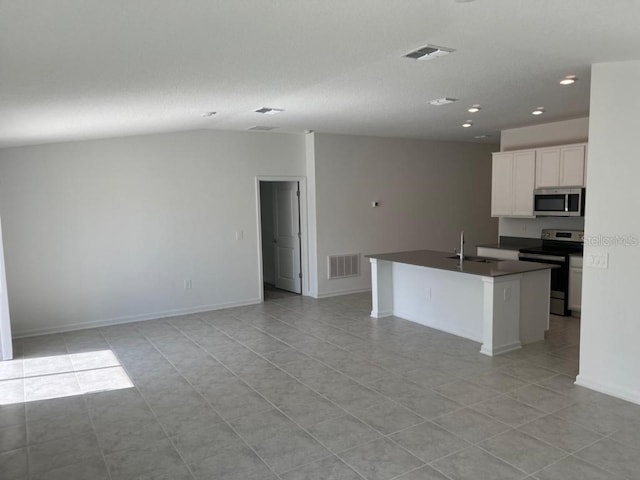 kitchen with a kitchen island with sink, stainless steel appliances, light tile patterned floors, white cabinets, and sink