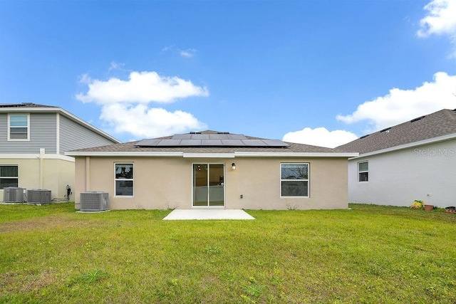 back of property featuring cooling unit and a lawn