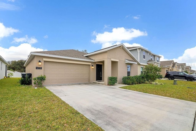 view of front of house featuring a garage and a front lawn