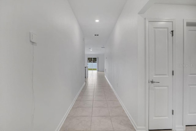 hallway with light tile patterned floors