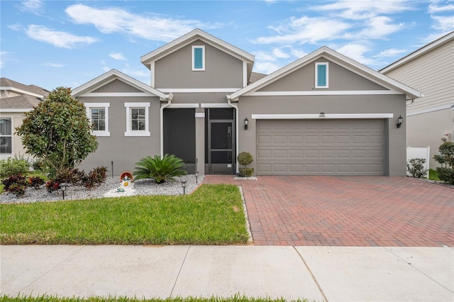 view of front of property with a front yard and a garage