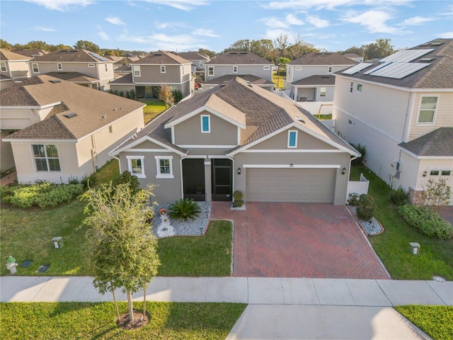 view of front of property with a front yard and a garage