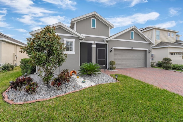 view of front of home featuring a front yard and a garage