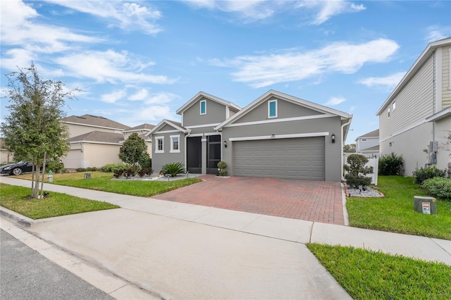 view of front of home with a garage and a front lawn