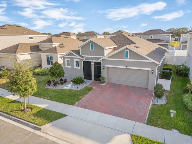 view of front of home featuring a garage and a front yard