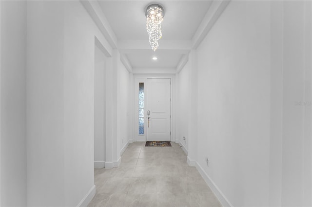 corridor featuring a chandelier