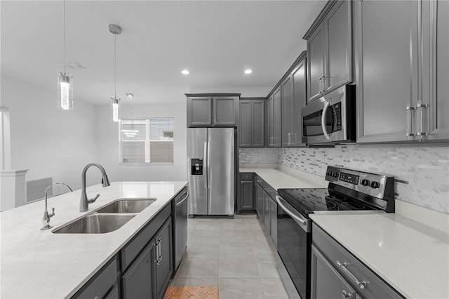 kitchen with sink, decorative light fixtures, light tile patterned floors, gray cabinetry, and appliances with stainless steel finishes