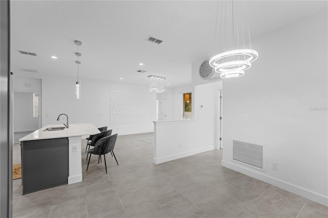 interior space with sink, an inviting chandelier, and light tile patterned floors