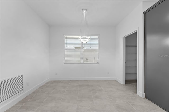 unfurnished dining area featuring a chandelier and light tile patterned floors